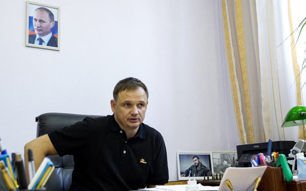 (FILES) In this file photo taken on July 20, 2022 Kirill Stremousov, deputy head of the Russian-backed Kherson administration, is pictured in his office, with a portrait of Russian President Vladimir Putin seen on the wall behind him, in the city of Kherson, amid the ongoing Russian military action in Ukraine. - The Russian-installed deputy head of Ukraine's region of Kherson, Kirill Stremousov, has died in a car crash, officials said on November 9, 2022. Stremousov, 45, was one of the highest-profile officials in Ukraine supporting Moscow's offensive. (Photo by STRINGER / AFP)