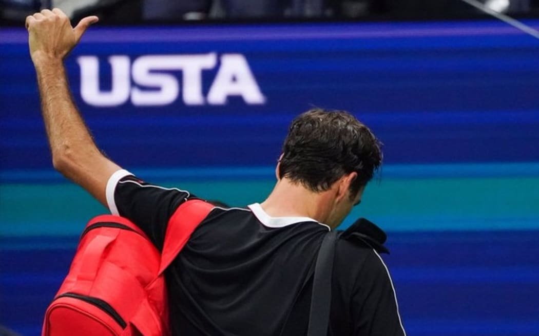 Roger Federer acknowledges the crowd as he leaves the court after his quarter loss.