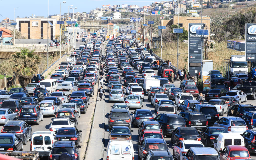 Motorists block the highway as they flee their villages in southern Lebanon along the coastal road through the city of Sidon on March 2, 2026. Israel bombarded Lebanon on March 2, expanding conflict across the region after the massive Israel-US attack on Iran that the US president to topple Tehran's ruling clerics.