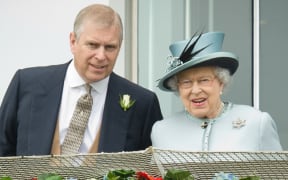 Prince Andrew, the Duke of York (L) speaks to Queen Elizabeth II on the Queens stand during Derby day at the Epsom Derby Festival, in Surrey, southern England, on June 1, 2013. AFP PHOTO/Leon Neal (Photo by LEON NEAL / AFP)