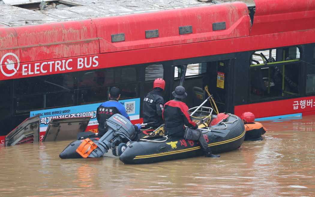 Rescuers battled to reach people trapped in a flooded tunnel in Cheongju, South Korea on Sunday.