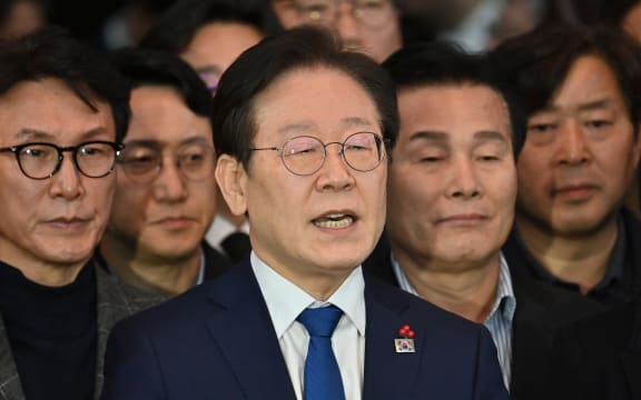 South Korea's main opposition Democratic Party leader Lee Jae-myung (C) speaks to the media at the National Assembly in Seoul on December 4, 2024, after South Korea President Yoon Suk Yeol declared martial law. - Yoon on December 3 declared martial law, accusing the opposition of being "anti-state forces" and saying he was acting to protect the country from "threats" posed by the North. (Photo by Jung Yeon-je / AFP)