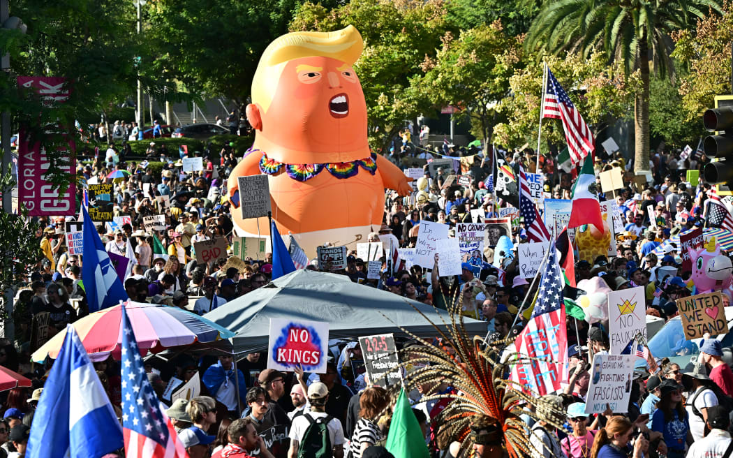 Protesters rally during the "No Kings" national day of protest in Los Angeles, California on October 18, 2025. From New York to San Francisco, millions of Americans are expected to hit the streets to voice their anger over President Donald Trump's policies at nationwide "No Kings" protests. (Photo by Frederic J. BROWN / AFP)