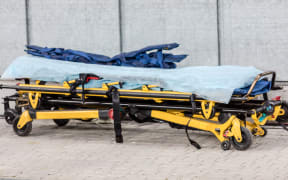 Paramedic ambulance equipment at football stadium for help.