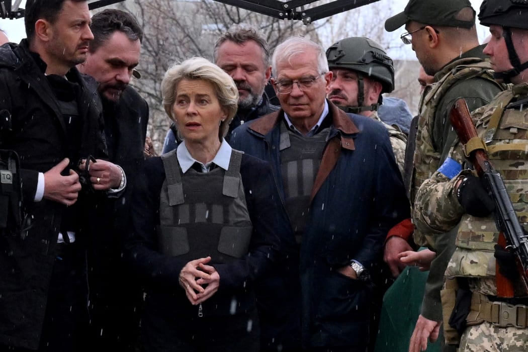 Slovakia's Prime Minister Eduard Heger (L) stands next to European Commission President Ursula von der Leyen, and European Union High Representative for Foreign Affairs and Security Policy Josep Borrell as they visit a mass grave in the town of Bucha, northwest of Kyiv on 8 April 2022.