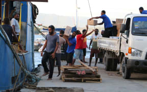 Donated goods being loaded onto a ship in Port Vila preparing to sail for Ambae.