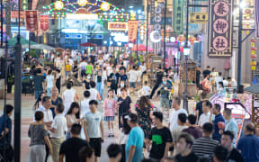 (220707) -- WUHAN, July 7, 2022 (Xinhua) -- Photo taken on July 2, 2022 shows the view of a commercial street in Wuhan, central China's Hubei Province. In recent years, Hubei Province has striven to combine its night economy with culture and tourism in innovative ways, thus enhancing the vitality and attraction of nighttime consumption. (Xinhua/Xiao Yijiu) (Photo by Xiao Yijiu / XINHUA / Xinhua via AFP)