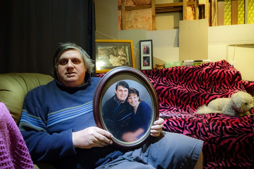 Laurie Anderson with an old photo of him and his partner Angela Blackmoore, who was murdered in their home 20 years ago.
