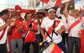 Peru football fans celebrate the arrival of their team at Auckland Airport.