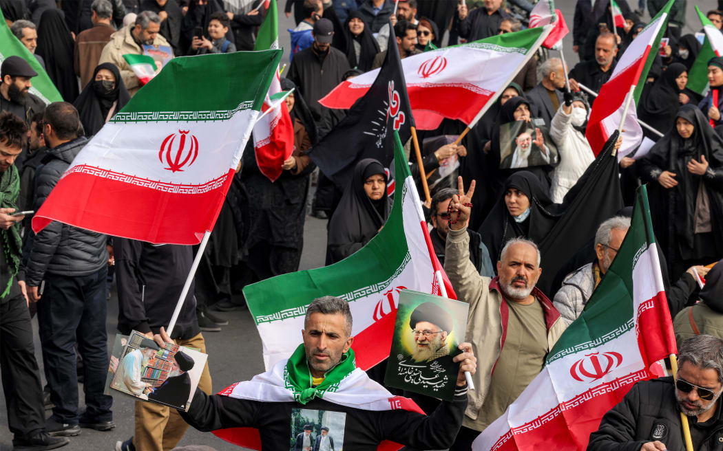 Demonstrators gather with Iranian national flags for a rally in support of the new Supreme Leader at Enghelab Square in central Tehran on March 9, 2026. Iran marked the appointment of Ayatollah Mojtaba Khamenei to replace his father as its supreme leader with a new barrage of missiles against Israel and the Gulf states on Monday, as the Middle East war sent oil prices soaring.