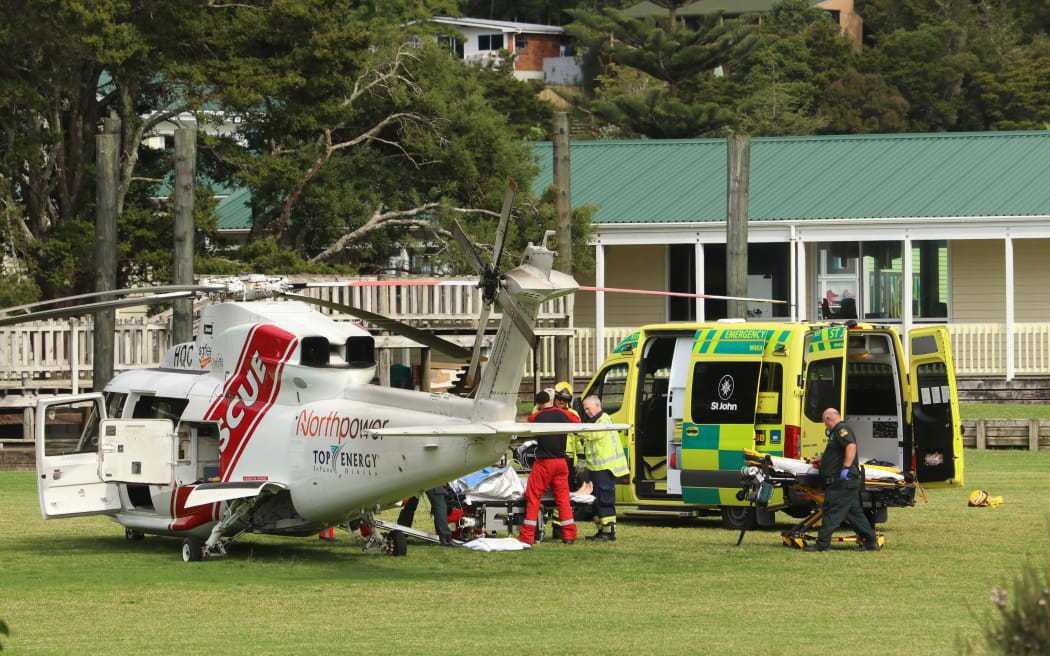 The ferry’s critically injured skipper is loaded onto the Northland Rescue Helicopter at Paihia School.
