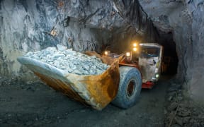 Working inside gold mine tunnel. Gold mining.