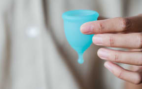 hand holding menstrual cup
