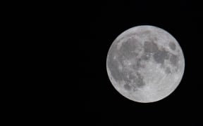 The first full moon of summer 2021, also known as the Strawberry Moon, the last supermoon of 2021 as seen in the Greek sky in Thessaloniki, Greece on June 24, 2021. (Photo by Nicolas Economou/NurPhoto) (Photo by Nicolas Economou / NurPhoto / NurPhoto via AFP)
