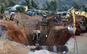 Moroccan authorities and firefighters work to get five-year-old child Rayan out of a well.