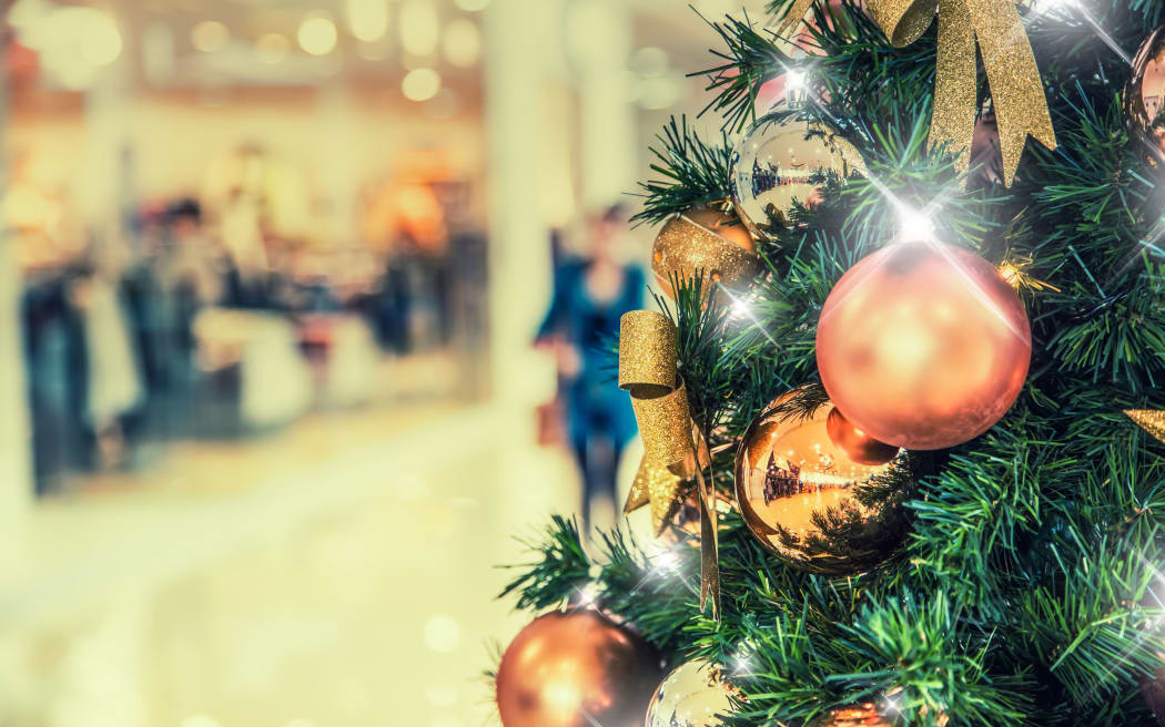 Christmas tree with gold decoration in shopping mall.Christmas clearance sales at the shopping mall.
