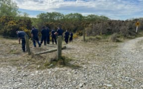 Police searching an area known as Bortons Pond on the Waitaki River.