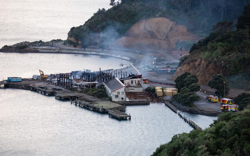 Fire crews dampen down the site of a blaze in a warehouse at Shelly Bay, Wellington.