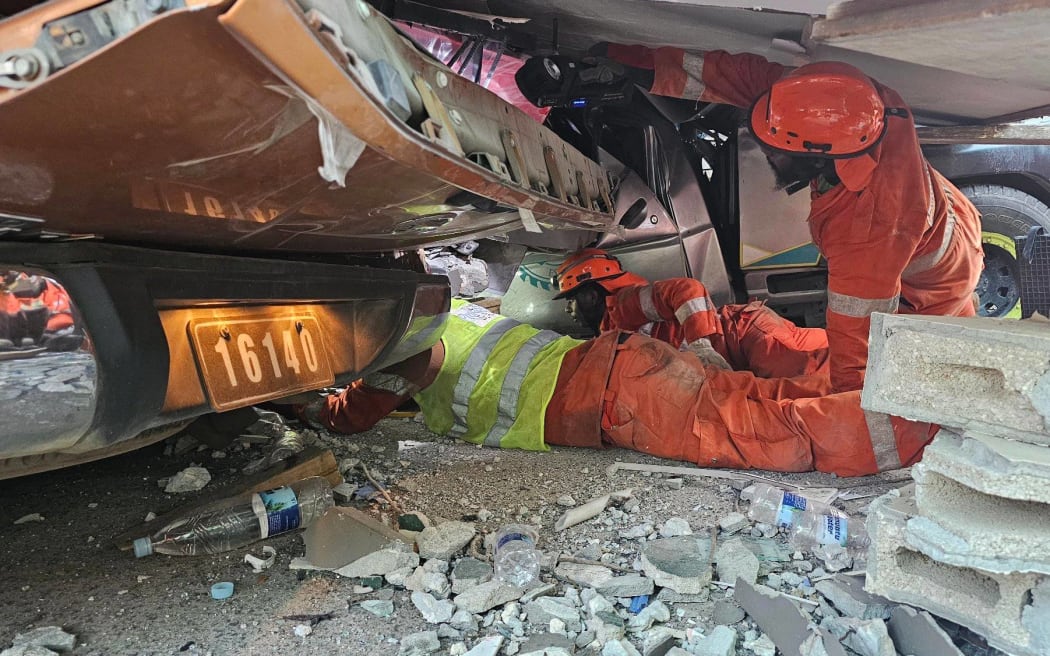 Rescuers search for trapped people after the 7.3 earthquake in Vanuatu.
