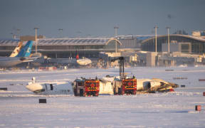 Emergency personnel work at the scene of a Delta Airlines plane crash at Toronto Pearson International Airport on 17 February 2025 in Toronto, Canada.