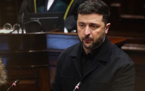 Ukraine's President Volodymyr Zelensky in the Dáil Chamber delivering a special speech in a joint sitting of the two Houses of Parliament in Leinster House Dublin, during his visit to the Irish capital on December 2, 2025. (Photo by TONY MAXWELL / POOL / AFP)