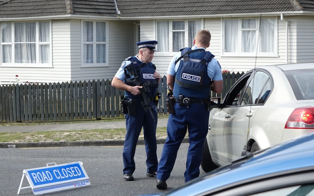 Police have evacuated residents of a Porirua street, north of Wellington, as they hunt for an armed offender who shot dead a police dog.