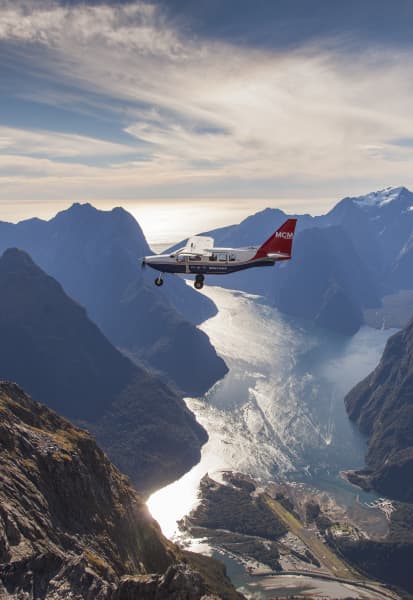 Small Airvan plane over Milford Sound.