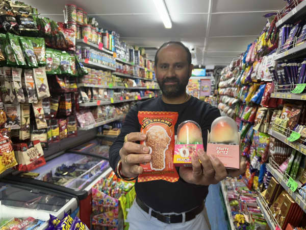 Photo of a man holding three ice-creams.