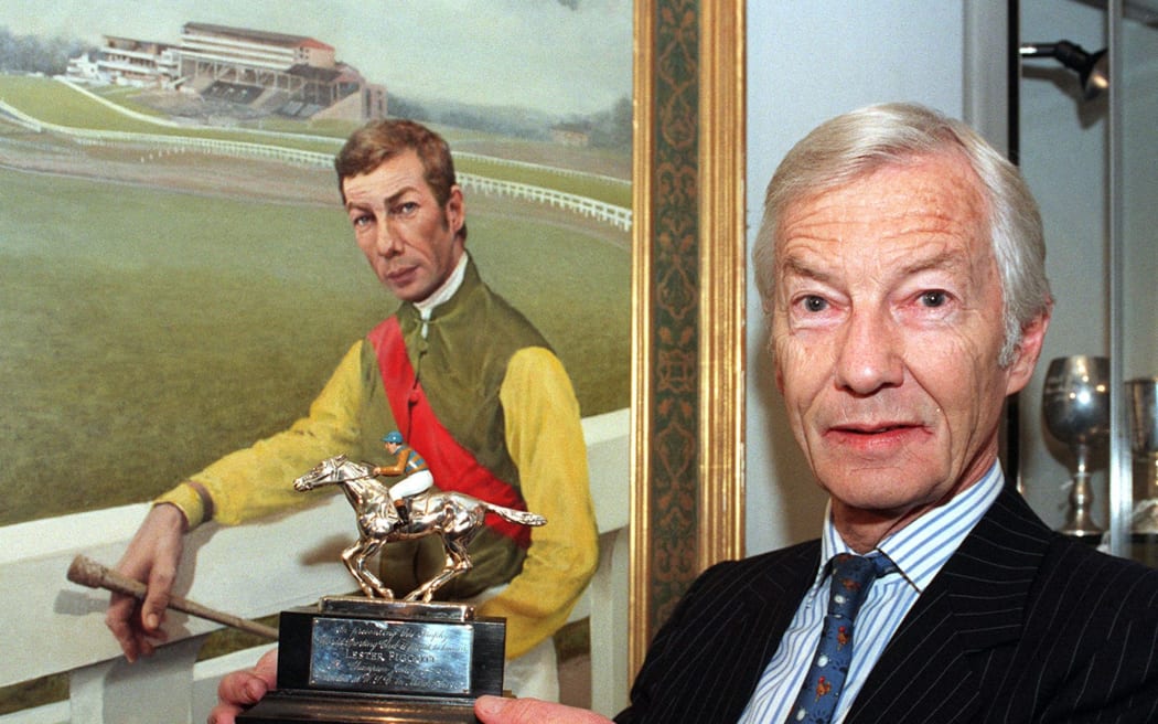 Racing legend Lester Piggott, poses for the media in this 1998 file image, at a preview of Sotheby's annual racing sale, which features some of his trophies and memorabilia. The collection, includes his 1966 Champion Jockey Trophy which is expected to fetch £3,000-£4,000 and a bronze sculpture of two horses by the French artist Mene - thought to be worth £8,000-£12,000.        == UK OUT == (Photo by FIONA HANSON / PA / AFP)