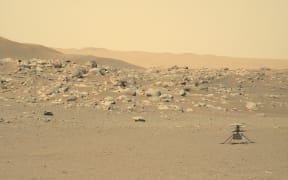 (FILES) This NASA photo obtained July 25, 2021 shows NASA's Ingenuity Mars Helicopter (R) captured by Mars Perseverance rover using its Left Mastcam-Z Camera, composed of a pair of cameras located high on the rover's mast, on June 15, 2021. NASA's Ingenuity Mars helicopter has made its final flight after sustaining damage to "one or more" of its rotor blades, the US space agency said on January 25, 2024. The mini-aircraft made history by achieving the first powered, controlled flight on another planet on April 19, 2021, and the last of its 72 flights took place on January 18, a statement said. (Photo by Handout / various sources / AFP) / RESTRICTED TO EDITORIAL USE - MANDATORY CREDIT "AFP PHOTO / NASA/JPL-Caltech/ASU/HANDOUT" - NO MARKETING - NO ADVERTISING CAMPAIGNS - DISTRIBUTED AS A SERVICE TO CLIENTS