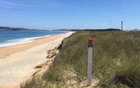 The beach east of Tiwai Point smelter where spent cell liner waste is kept under an impermeable cover.
