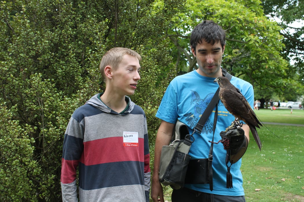 A photo of Rob Lawry showing the falcon to a student, Aaron Reed.