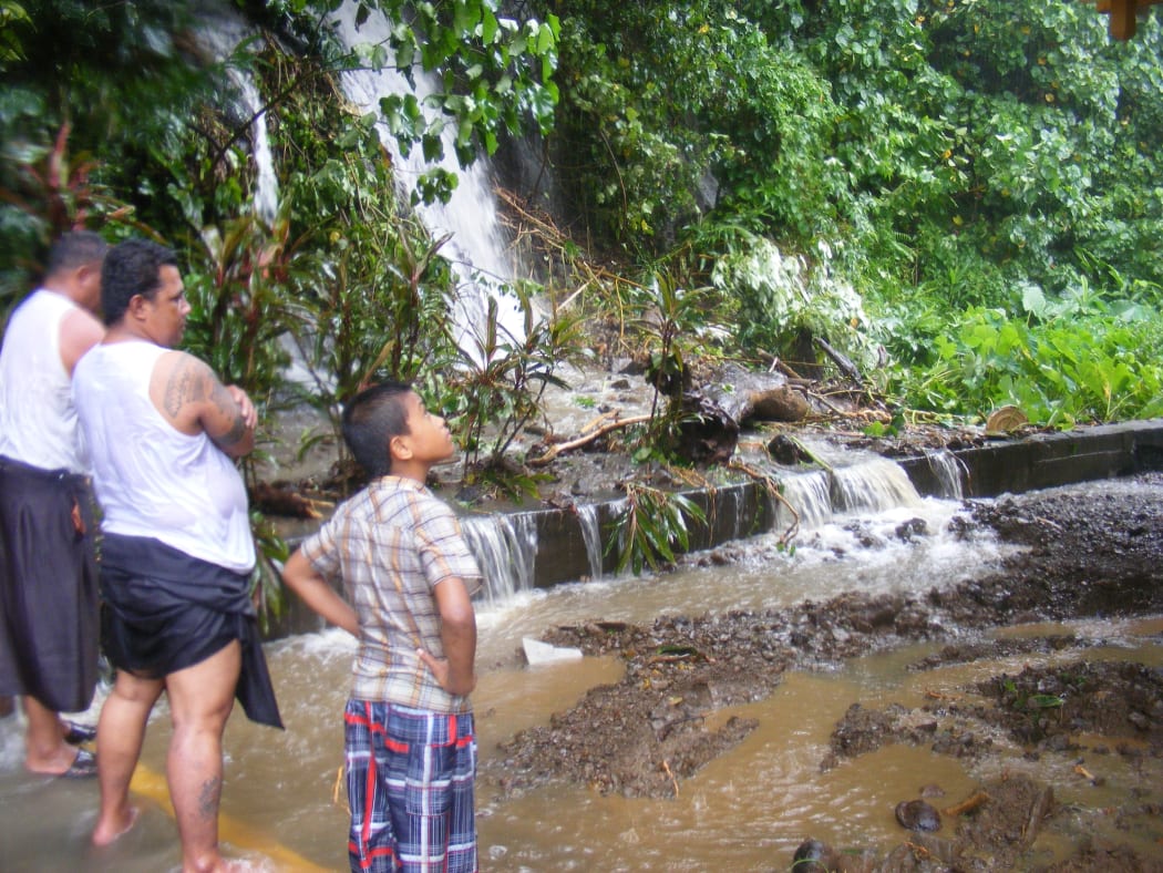 Locals in Fagatogo Village, American Samoa, inspect a mudslide