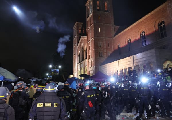 LOS ANGELES, CALIFORNIA - MAY 02: California Highway Patrol (CHP) officers clear a pro-Palestinian encampment as a police helicopter flies after dispersal orders were given at the University of California, Los Angeles (UCLA) campus, on May 2, 2024 in Los Angeles, California. The camp was declared ‘unlawful’ by the university and more than 100 protestors who refused to leave were detained during the operation. Pro-Palestinian encampments have sprung up at college campuses around the country with some protestors calling for schools to divest from Israeli interests amid the ongoing war in Gaza.   Mario Tama/Getty Images/AFP (Photo by MARIO TAMA / GETTY IMAGES NORTH AMERICA / Getty Images via AFP)