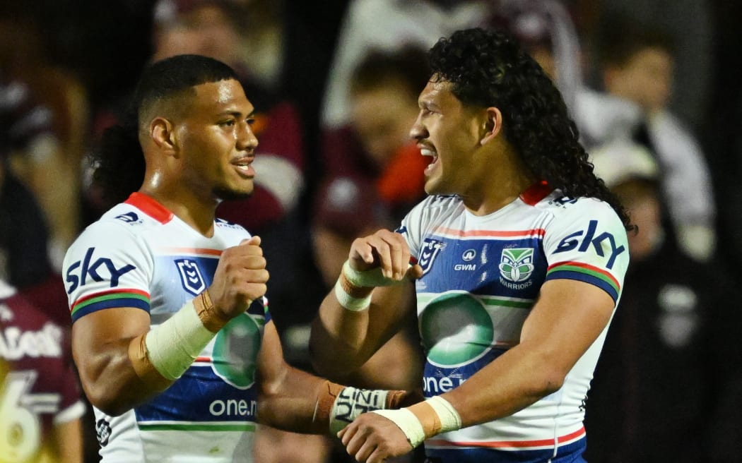 Dallin Watene-Zelezniak of the Warriors celebrates after scoring a try.