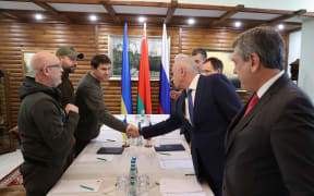 From left, members of Ukrainian delegation, Defence Minister Oleksii Reznikov, Davyd Arakhamia and Mykhailo Podoliyak and from right, members of Russian delegation Andrei Rudenko, Alexander Fomin, Vladimir Medinsky and Leonid Slutsky during Russian-Ukrainian talks, in Belarus.