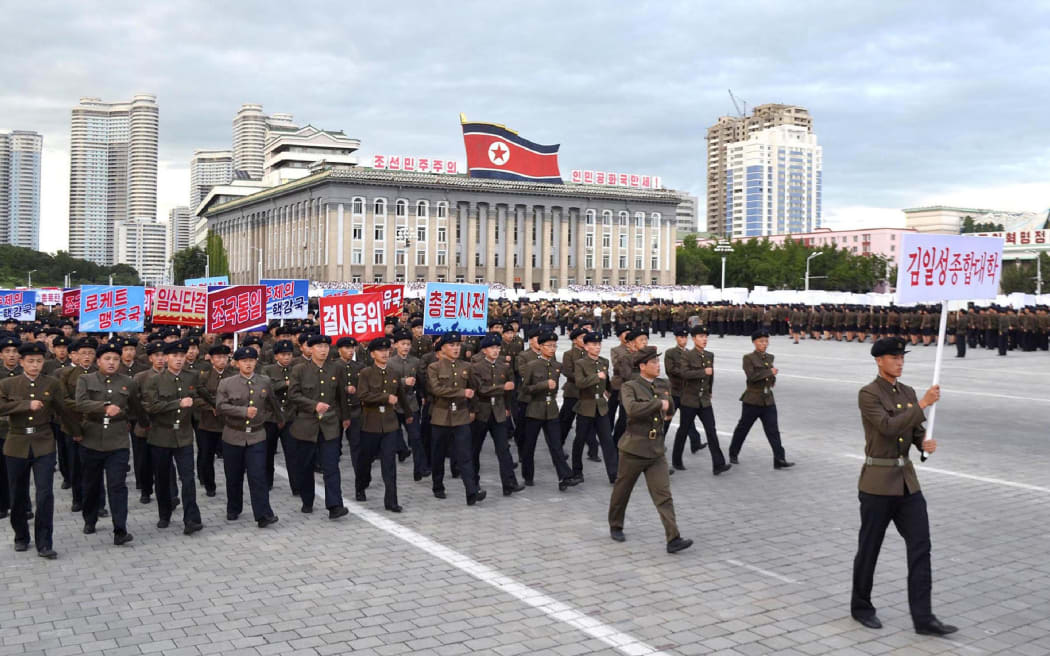 North Korean working youth and university students on the march.