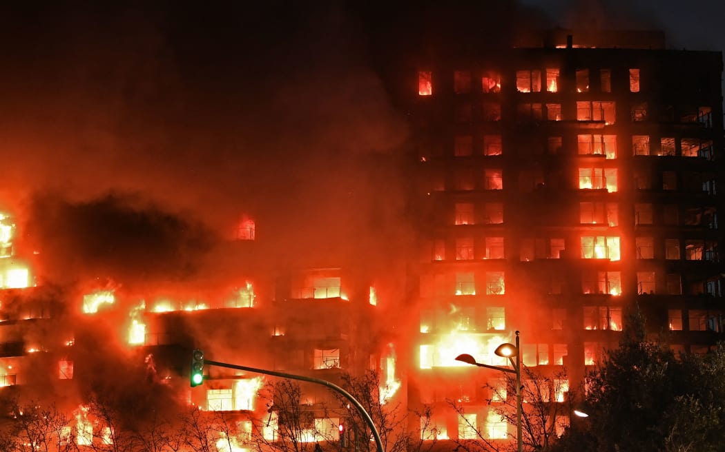 A huge fire rages through a multistorey residential block in Valencia on February 22, 2024. (Photo by Jose Jordan / AFP)