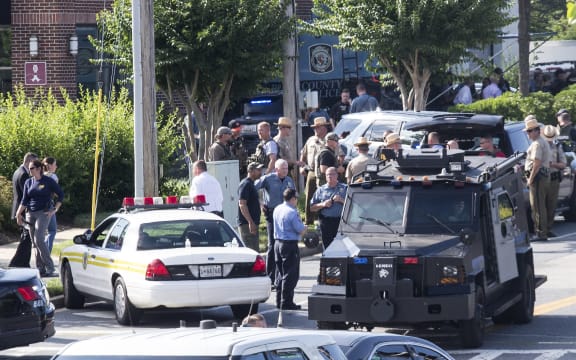 Police respond to a shooting in Annapolis, Maryland where at least five people were killed when a gunman opened fire inside the offices of the Capital Gazette newspaper.