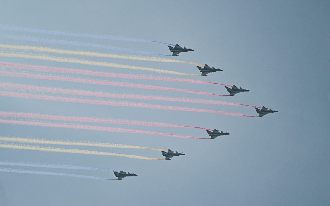 Chengdu J-10 Vigorous Dragon fighters perform a flyby during a military parade marking the 80th anniversary of victory over Japan and the end of World War II, in Beijing’s Tiananmen Square on September 3, 2025. (Photo by Pedro Pardo / AFP)