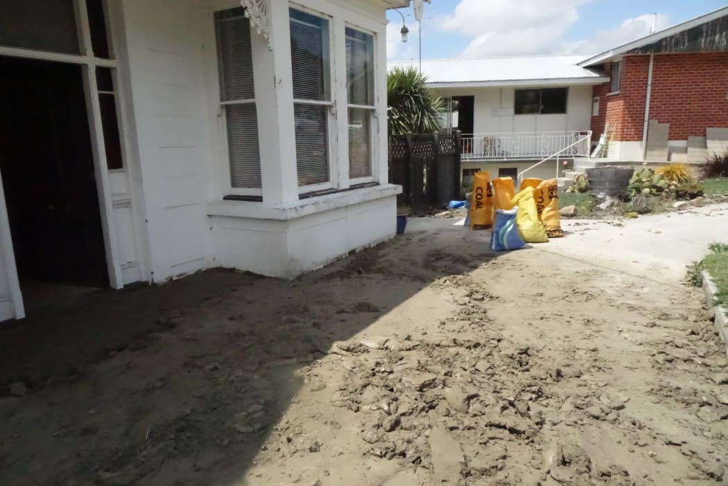 Sandbags being filled from Sunday's silt dump in case of another downpour.