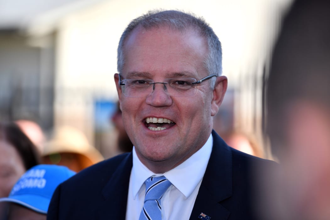 Australia's Prime Minister Scott Morrison talks to the media outside a polling booth during Australia's general election in Sydney on May 18, 2019.