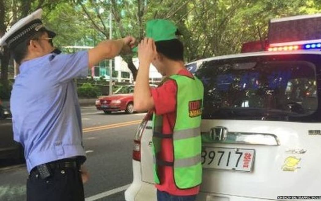 Jaywalkers in the Chinese city of Shenzhen are forced to wear green hats.