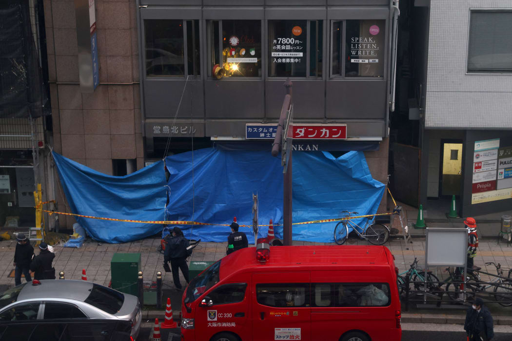 Emergency vehicles are seen in front of an office building, where a fire broke out in Osaka on December 17,2021.