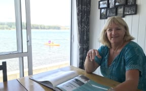 Sandi Dunn and the book she wrote on  Whananaki North baches.