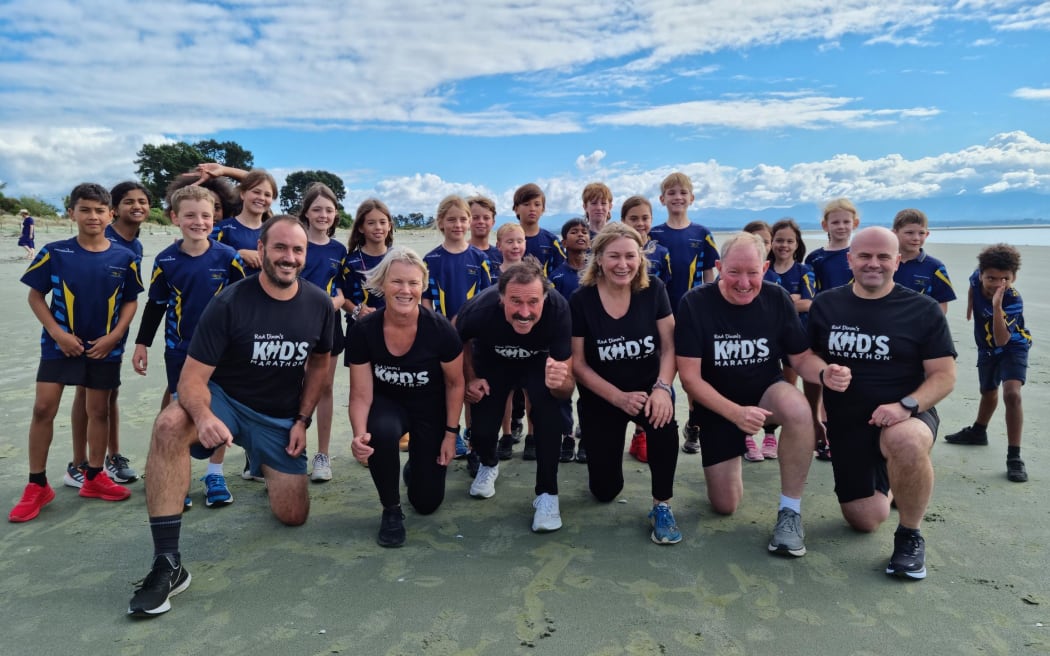 From left, Top South media managing director Andrew Board, Tāhunanui School principal Barbara Bowen, Olympians Rod Dixon and Lorraine Moller, Nelson mayor Nick Smith and Saint Paul's Catholic School board chair Lester Binns with pupils from Tāhunanui School.