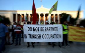 Kurds living in Athens protest near the Turkish Embassy against the Turkish offensive in northern Syria.