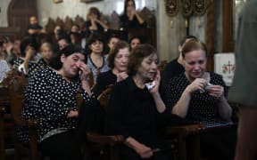 Christian Palestinians mourn Saad Salameh and Foumia Ayyad, killed earlier in an Israeli strike that hit the Holy Family Church in Gaza City, during their funeral ceremony at the Saint Porphyrius Church on July 17, 2025. An Israeli strike on Gaza's only Catholic church killed three people on July 17, the Latin Patriarchate of Jerusalem said, as Israel said it "never targets" religious sites and regretted any harm to civilians. (Photo by Omar AL-QATTAA / AFP)