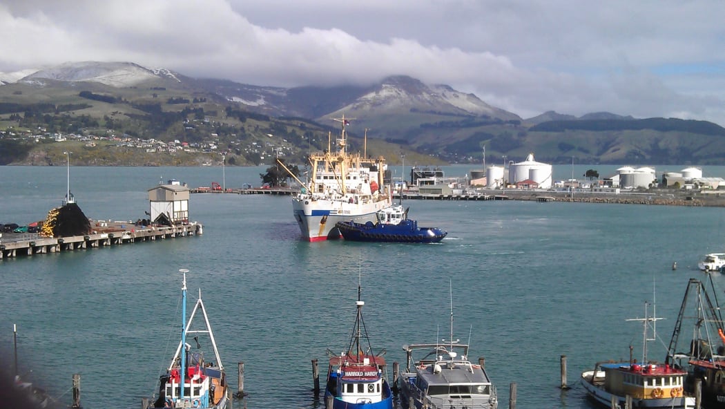 Crew from the Amaltal Columbia return to port on a rescue fishing vessel.