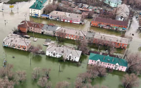 An aerial picture taken on April 8, 2024 shows the flooded part of the city of Orsk, Russia's Orenburg region, southeast of the southern tip of the Ural Mountains. Russia said on April 8, 2024 that more than 10,000 residential buildings were flooded across the Urals, Volga area and western Siberia as emergency services evacuated cities threatened by rising rivers. On April 7, Russia declared a federal emergency in the Orenburg region, where the Ural river flooded much of the city of Orsk and is now reaching dangerous levels in the main city of Orenburg. Much of the city of Orsk has been flooded after torrential rain burst a nearby dam. (Photo by Anatoliy Zhdanov / Kommersant Photo / AFP) / Russia OUT